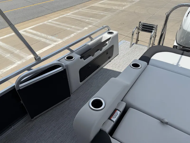 Slide: The Image of 2025 Avalon LSZ Versatile Rear Bench with cup holders and ladder on a pontoon boat. - 25