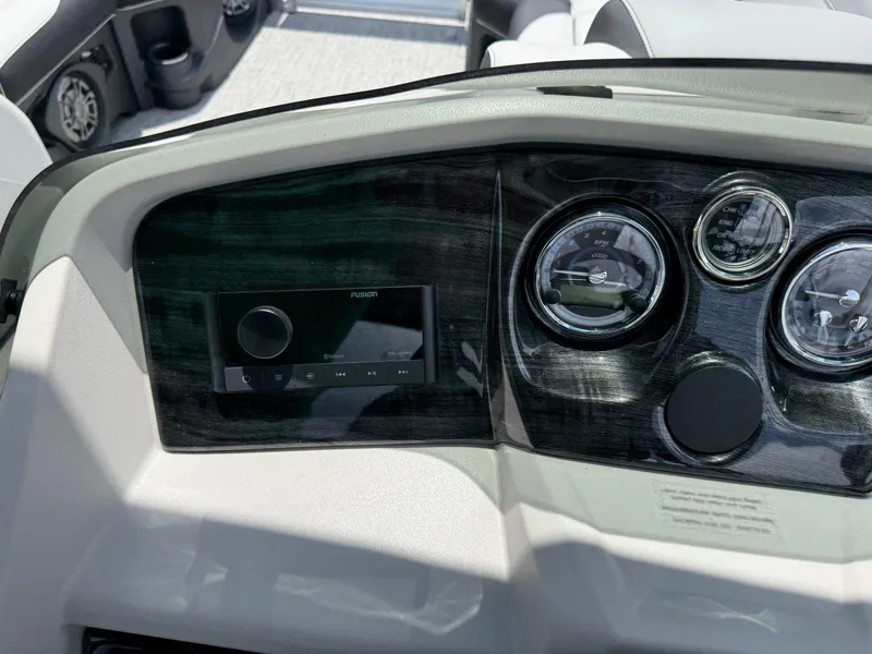 Slide: The Image of Dashboard of 2025 Avalon LSZ Versatile Rear Bench boat with gauges and controls. - 32