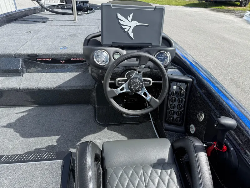Slide: The Image of 2026 Phoenix 919 ZXL boat cockpit with steering wheel and digital display. - 11