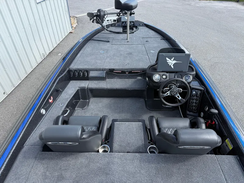 Slide: The Image of 2026 Phoenix 919 ZXL boat interior with dual seats, steering console, and carpeted deck. - 13