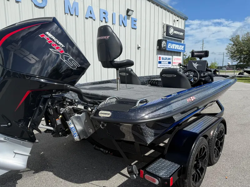 Slide: The Image of 2026 Phoenix 919 ZXL boat with Mercury Pro XS engine at a marine dealership. - 14
