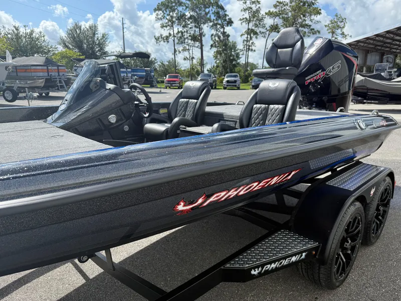 Slide: The Image of 2026 Phoenix 919 ZXL boat with sleek design and modern features, parked outdoors. - 4
