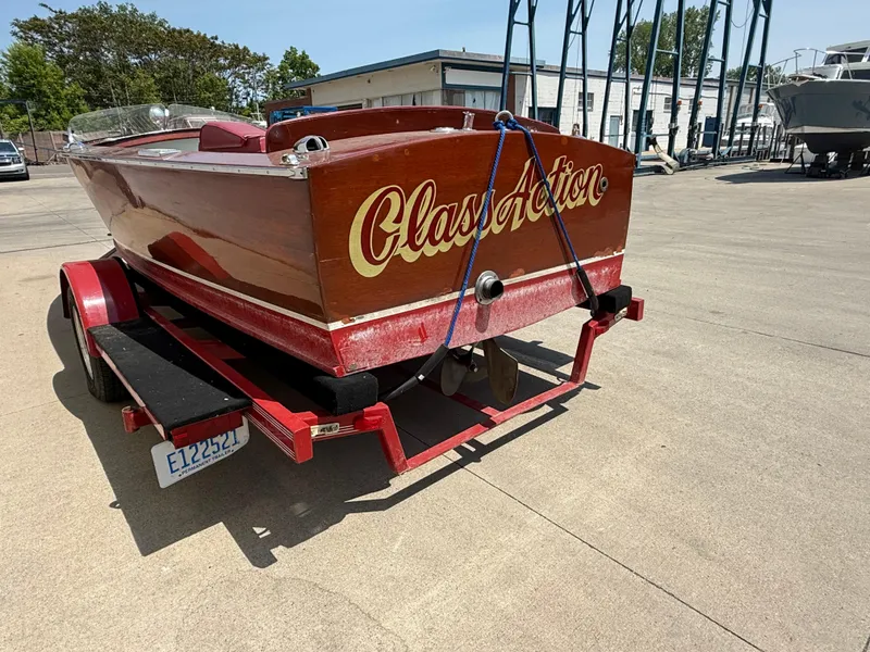 Slide: The Image of 1953 Chris-Craft 17’ Sportsman boat on trailer, featuring "Class Action" name on stern. - 10