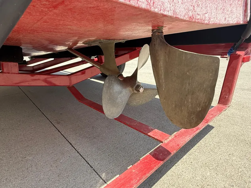 Slide: The Image of Propeller and rudder of a 1953 Chris-Craft 17’ Sportsman boat on a red trailer. - 18