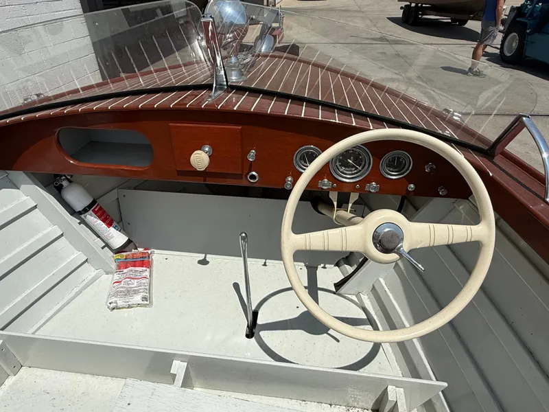 Slide: The Image of 1953 Chris-Craft 17’ Sportsman boat dashboard with vintage steering wheel and gauges. - 6