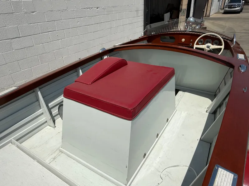 Slide: The Image of 1953 Chris-Craft 17’ Sportsman boat interior with red seat and wooden details. - 8