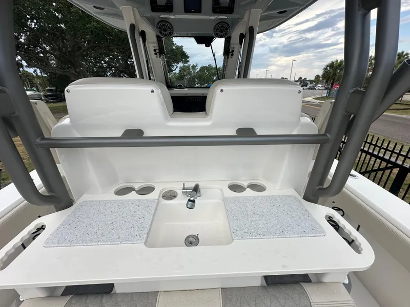 Slide: The Image of 2024 Solace 32 CS boat, sleek design, docked near a bridge on sunny day. - 15