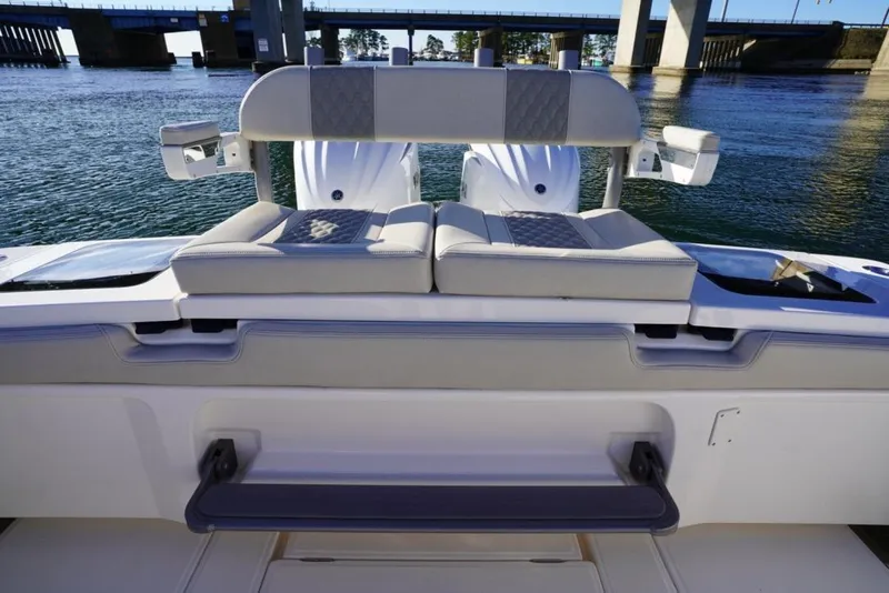 Slide: The Image of 2024 Solace 32 CS boat interior with cushioned seating and water view. - 18