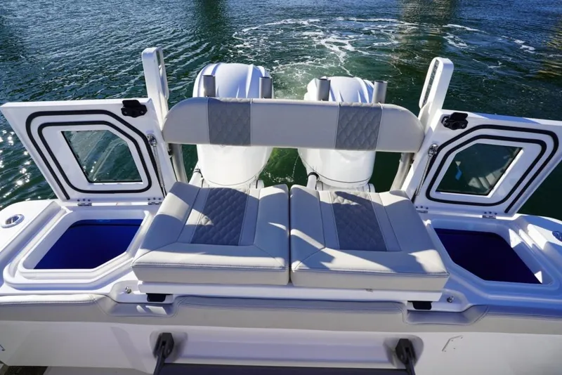 Slide: The Image of 2024 Solace 32 CS boat with cushioned seating and open storage compartments. - 19