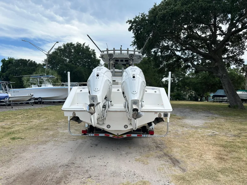 Slide: The Image of 2024 Solace 32 CS boat cruising on water near a bridge. - 2