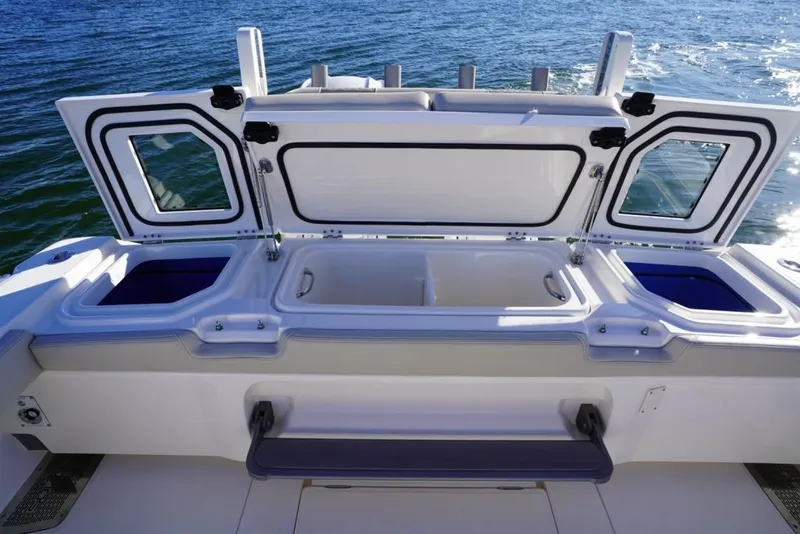 Slide: The Image of 2024 Solace 32 CS boat with open storage compartments on the deck. - 21
