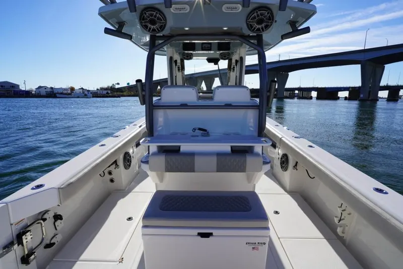 Slide: The Image of 2024 Solace 32 CS boat interior with seating, speakers, and bridge view. - 22