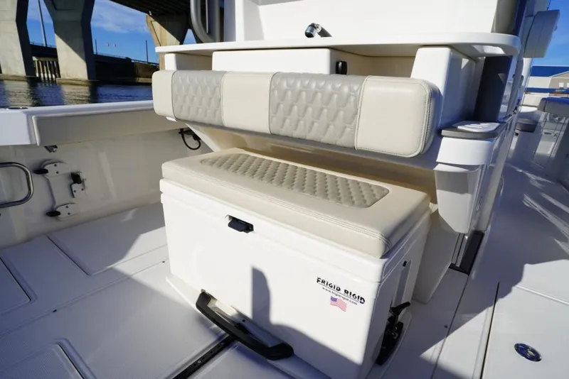 Slide: The Image of 2024 Solace 32 CS boat interior with cushioned seating and storage compartment. - 25