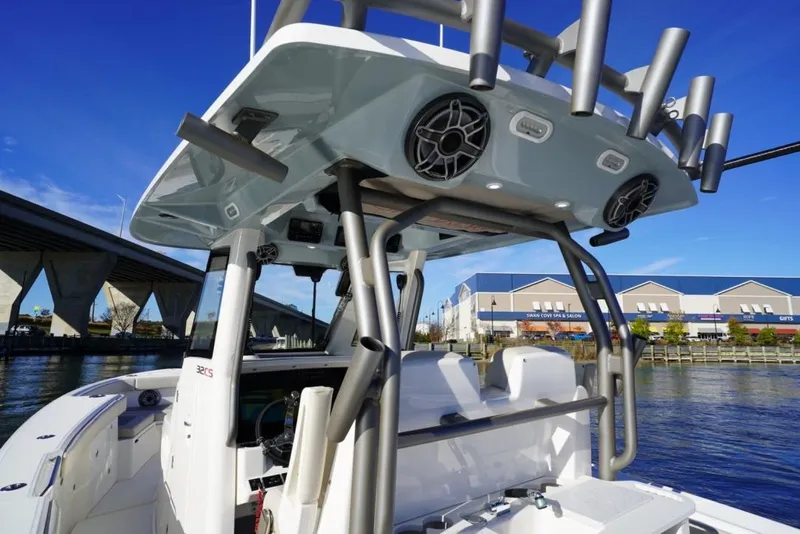 Slide: The Image of 2024 Solace 32 CS boat with advanced features, docked near a bridge and waterfront buildings. - 30