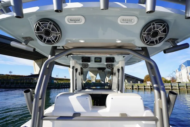 Slide: The Image of 2024 Solace 32 CS boat interior with speakers and control panel, under a bridge. - 31