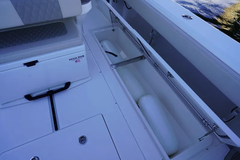 Slide: The Image of 2024 Solace 32 CS boat interior with storage compartment and seating. - 37