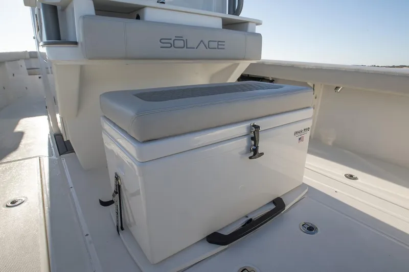 Slide: The Image of 2024 Solace 32 CS boat cruising on water under a bridge. - 7