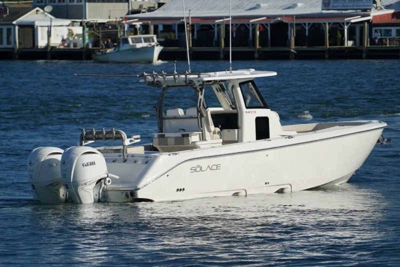 Slide: The Image of 2024 Solace 32 CS boat with twin Yamaha engines on the water. - 9
