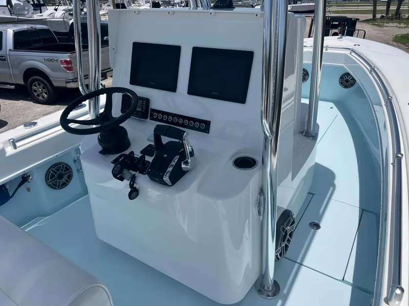Slide: The Image of 2023 Contender 25 Tournament boat dashboard with dual screens and steering wheel. - 10