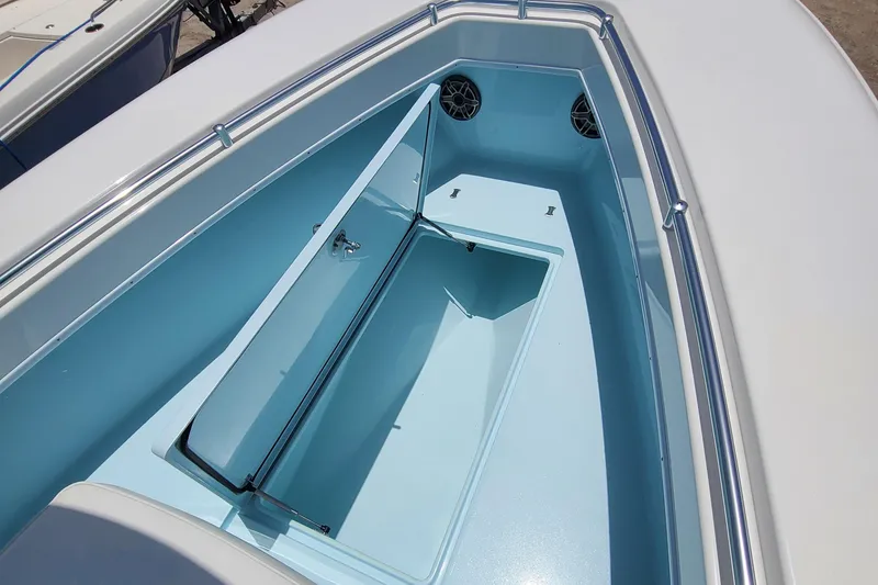 Slide: The Image of 2023 Contender 25 Tournament boat interior with storage compartment and speakers. - 23