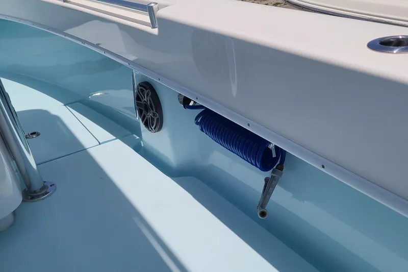 Slide: The Image of 2023 Contender 25 Tournament boat interior with blue hose and speaker. - 24