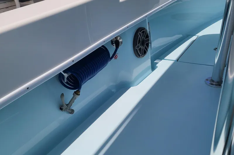Slide: The Image of 2023 Contender 25 Tournament boat interior with coiled hose and speaker. - 25