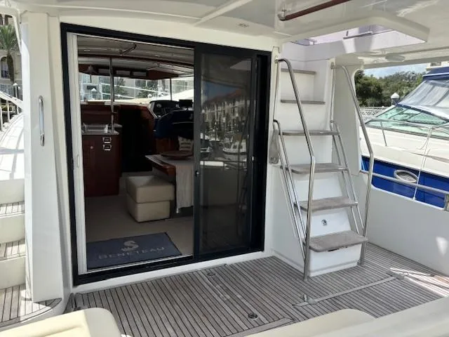 Slide: The Image of 2014 Beneteau Swift Trawler 44, open deck view with interior and stairs. - 12