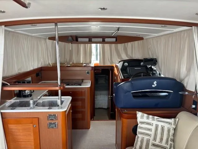 Slide: The Image of Interior of 2014 Beneteau Swift Trawler 44 with kitchen and helm station. - 14