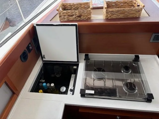Slide: The Image of 2014 Beneteau Swift Trawler 44 kitchen with stove, fridge, and wicker baskets. - 16