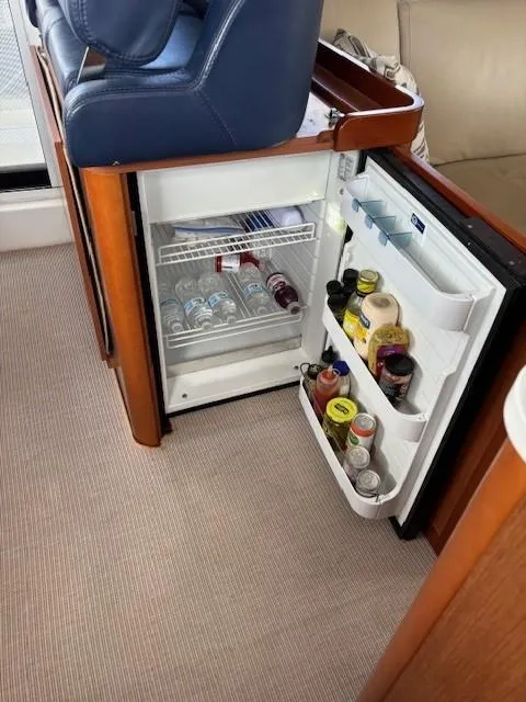 Slide: The Image of Mini fridge stocked with beverages and condiments on a 2014 Beneteau Swift Trawler 44. - 18