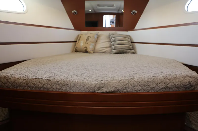 Slide: The Image of 2014 Beneteau Swift Trawler 44 cabin with cozy bed and pillows. - 21