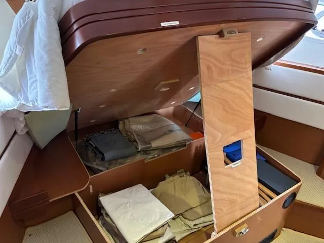 Slide: The Image of 2014 Beneteau Swift Trawler 44 interior storage with neatly organized clothing. - 22