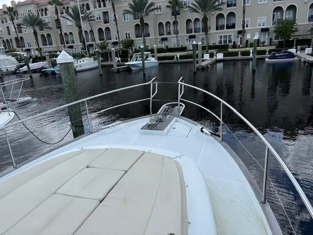 Slide: The Image of 2014 Beneteau Swift Trawler 44 docked in a marina with waterfront buildings. - 26