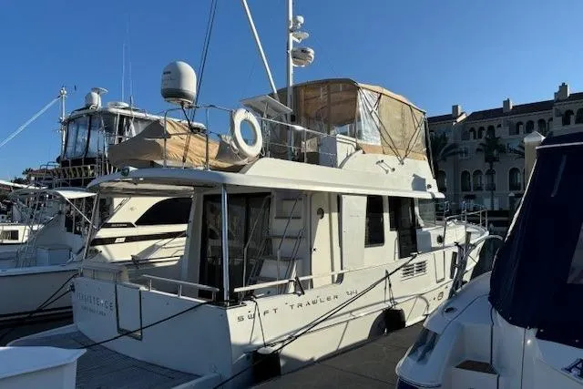 Slide: The Image of 2014 Beneteau Swift Trawler 44 docked at marina under clear blue sky. - 30