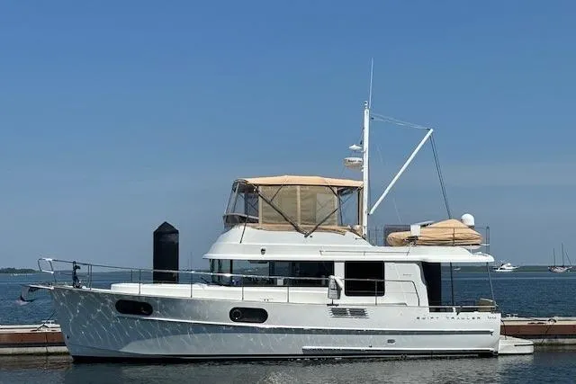 Slide: The Image of 2014 Beneteau Swift Trawler 44 docked, featuring a sleek design and spacious deck. - 31