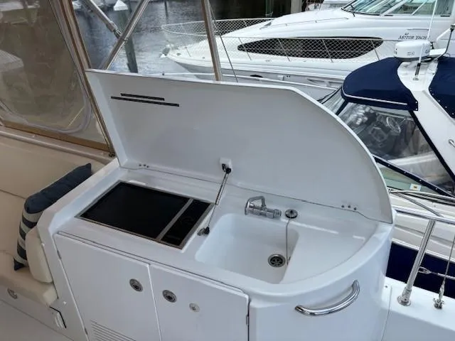 Slide: The Image of Outdoor kitchenette on 2014 Beneteau Swift Trawler 44, featuring sink and cooktop. - 5