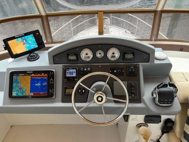 Slide: The Image of 2014 Beneteau Swift Trawler 44 helm with navigation equipment and steering wheel. - 7