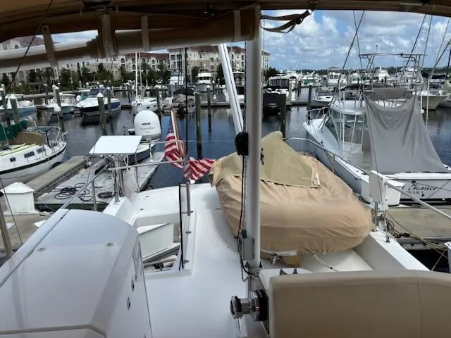 Slide: The Image of 2014 Beneteau Swift Trawler 44 docked at a marina with other boats. - 9