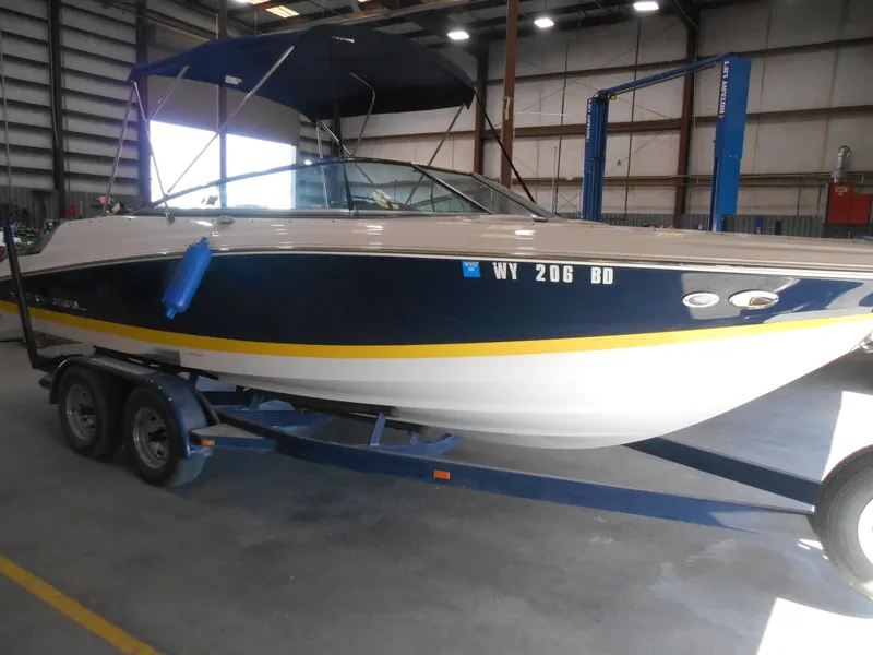 Slide: The Image of 2006 Regal 2200SLR boat on trailer in warehouse setting. - 3