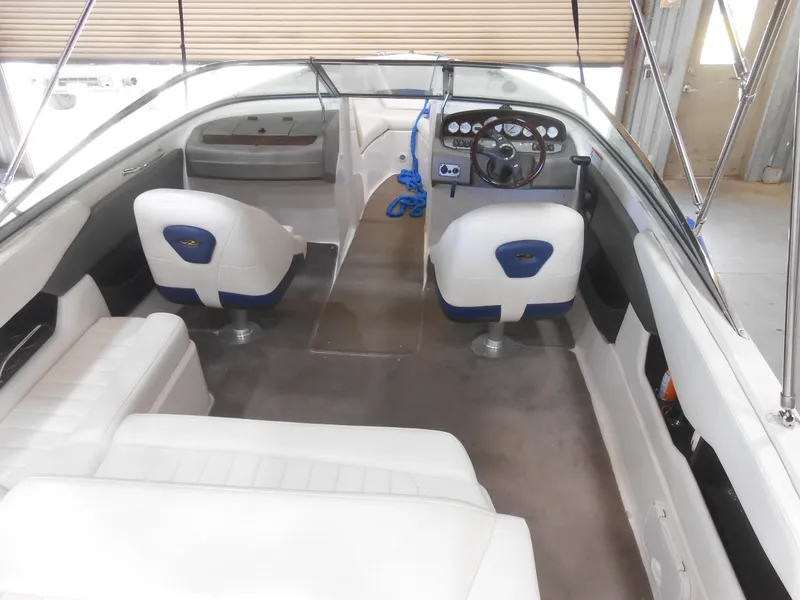 Slide: The Image of 2006 Regal 2200SLR boat interior with white seating and steering console. - 4
