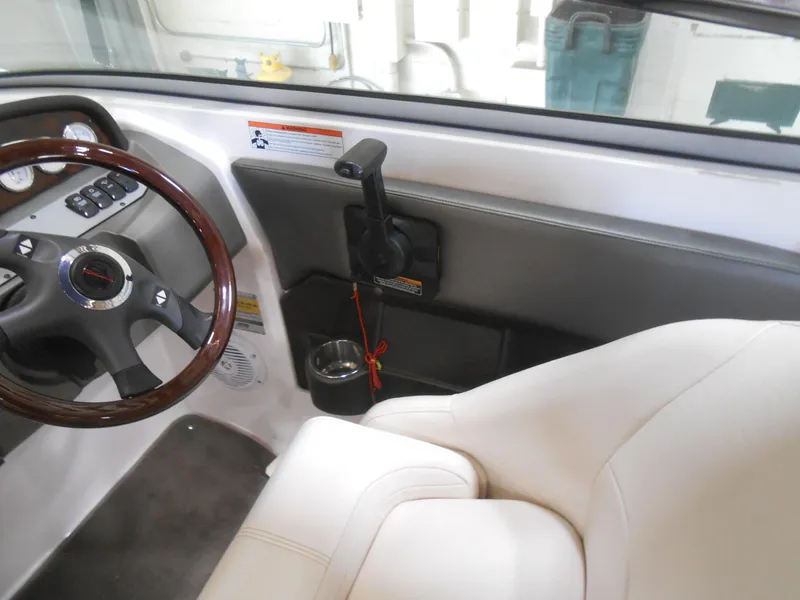 Slide: The Image of Interior of a 2006 Regal 2200SLR boat showing steering wheel and controls. - 6