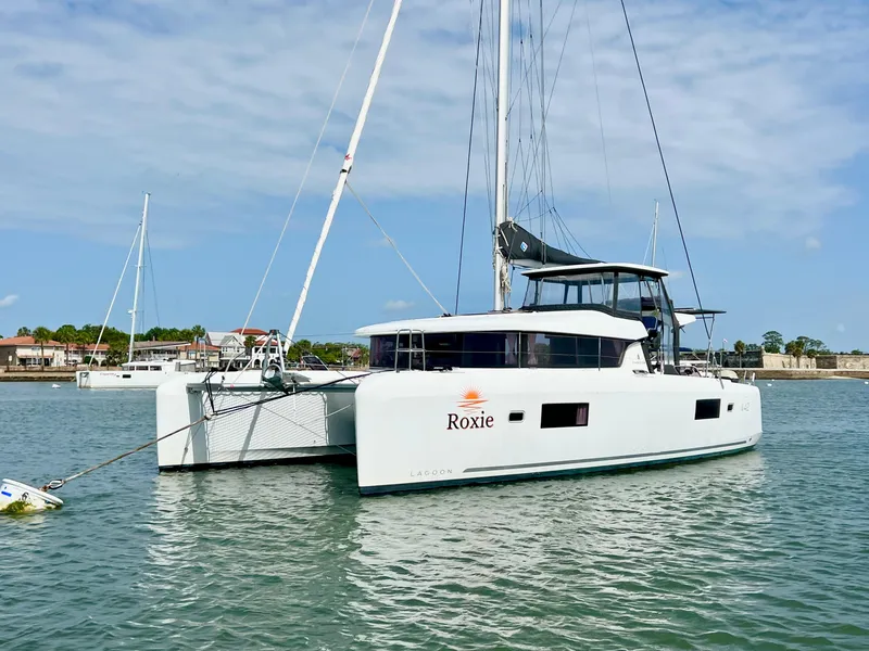 The Image of 2024 Lagoon 42 catamaran "Roxie" anchored in calm waters. - 0
