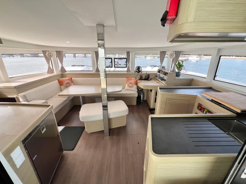 Slide: The Image of Modern interior of 2024 Lagoon 42 catamaran with spacious seating and panoramic windows. - 35