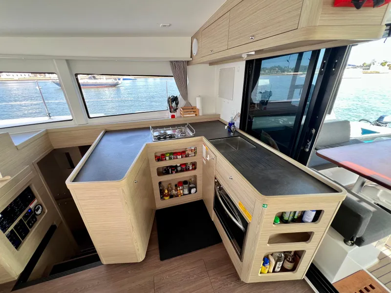 Slide: The Image of Modern kitchen interior of 2024 Lagoon 42 catamaran with sleek countertops and ample storage. - 36