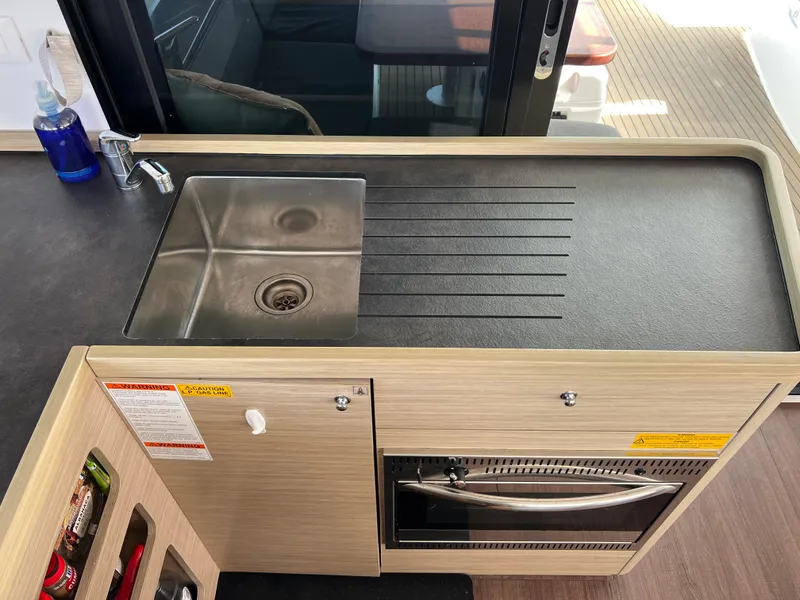 Slide: The Image of Modern kitchen sink and counter in 2024 Lagoon 42 yacht interior. - 39