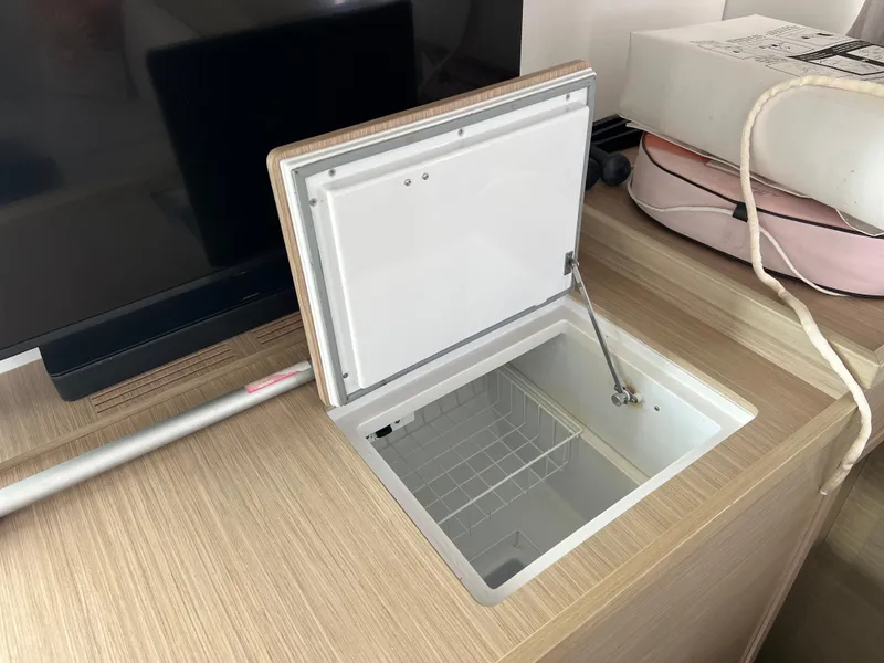 Slide: The Image of Open storage compartment on a 2024 Lagoon 42 yacht, featuring a wooden countertop. - 40