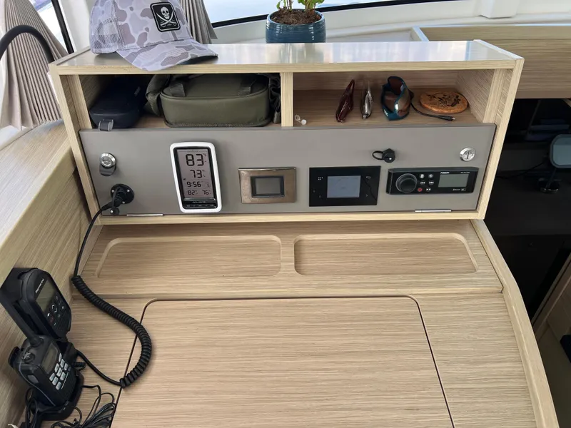 Slide: The Image of Control panel of a 2024 Lagoon 42 yacht with navigation instruments and storage compartments. - 45