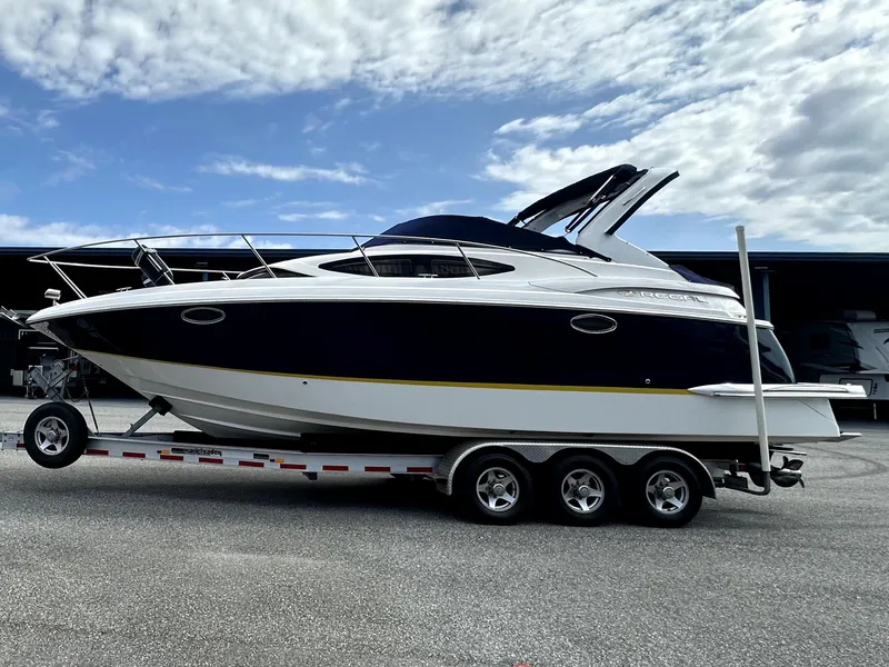 The Image of 2007 Regal 3060 Window Express boat on a trailer under a partly cloudy sky. - 0