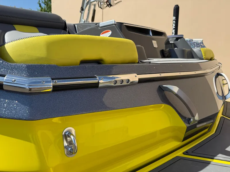 Slide: The Image of 2019 MasterCraft X22 boat with vibrant yellow and gray detailing, showcasing sleek design and luxury features. - 12