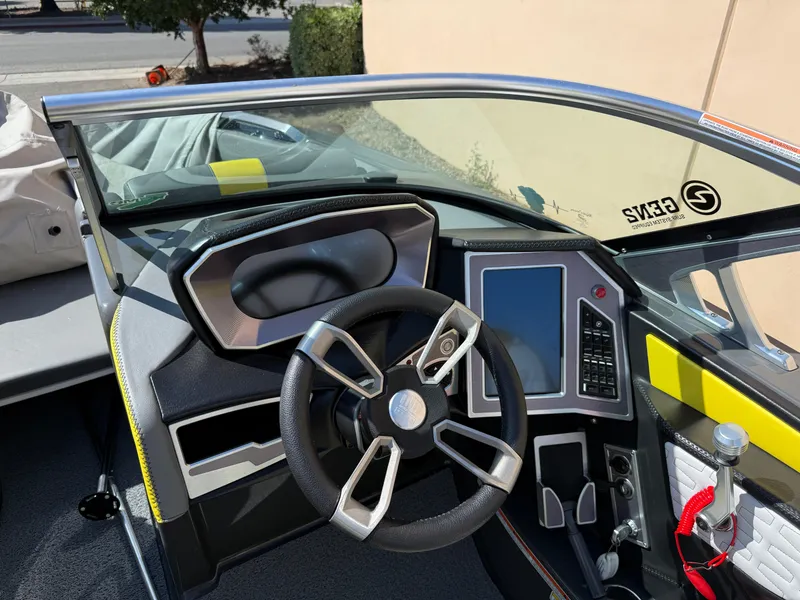 Slide: The Image of 2019 MasterCraft X22 boat dashboard with modern steering and touchscreen controls. - 16